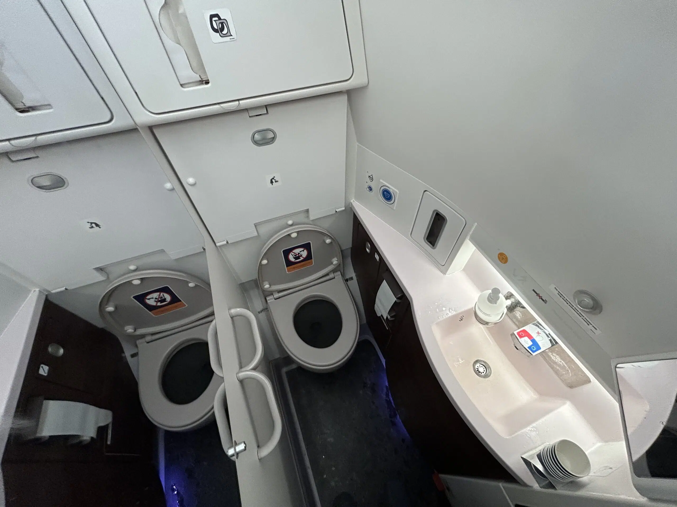 airplane bathroom with toilet and sink