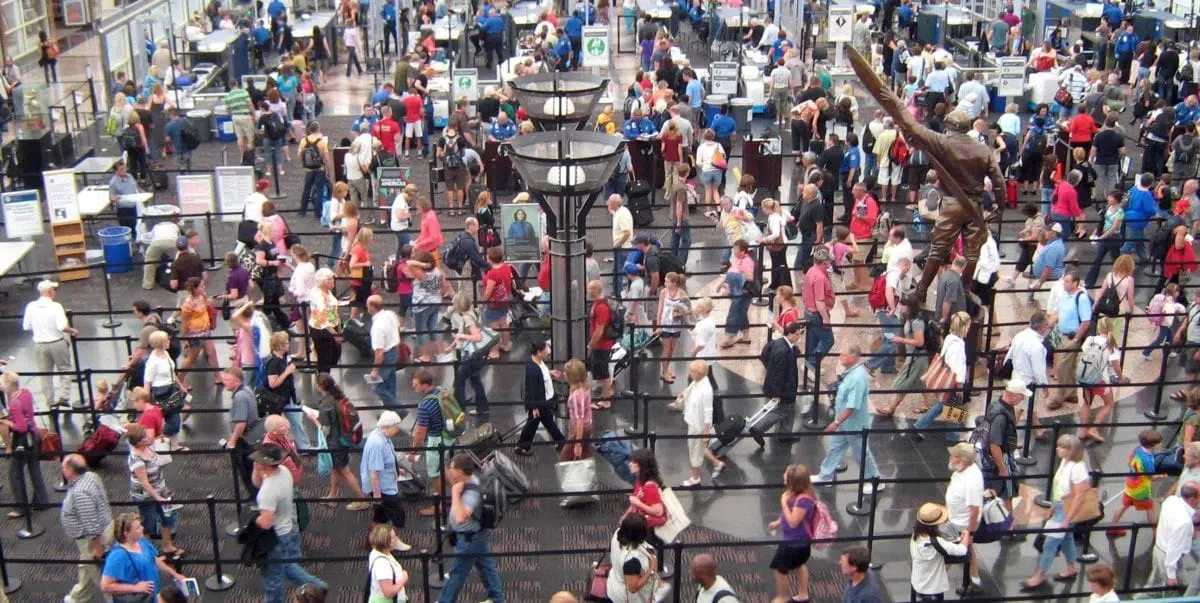 travelers winding through an airport security line