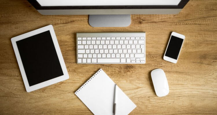 Office supplies, gadgets on wooden table, top view