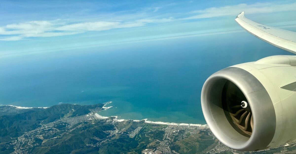 plane flying over the coast and ocean