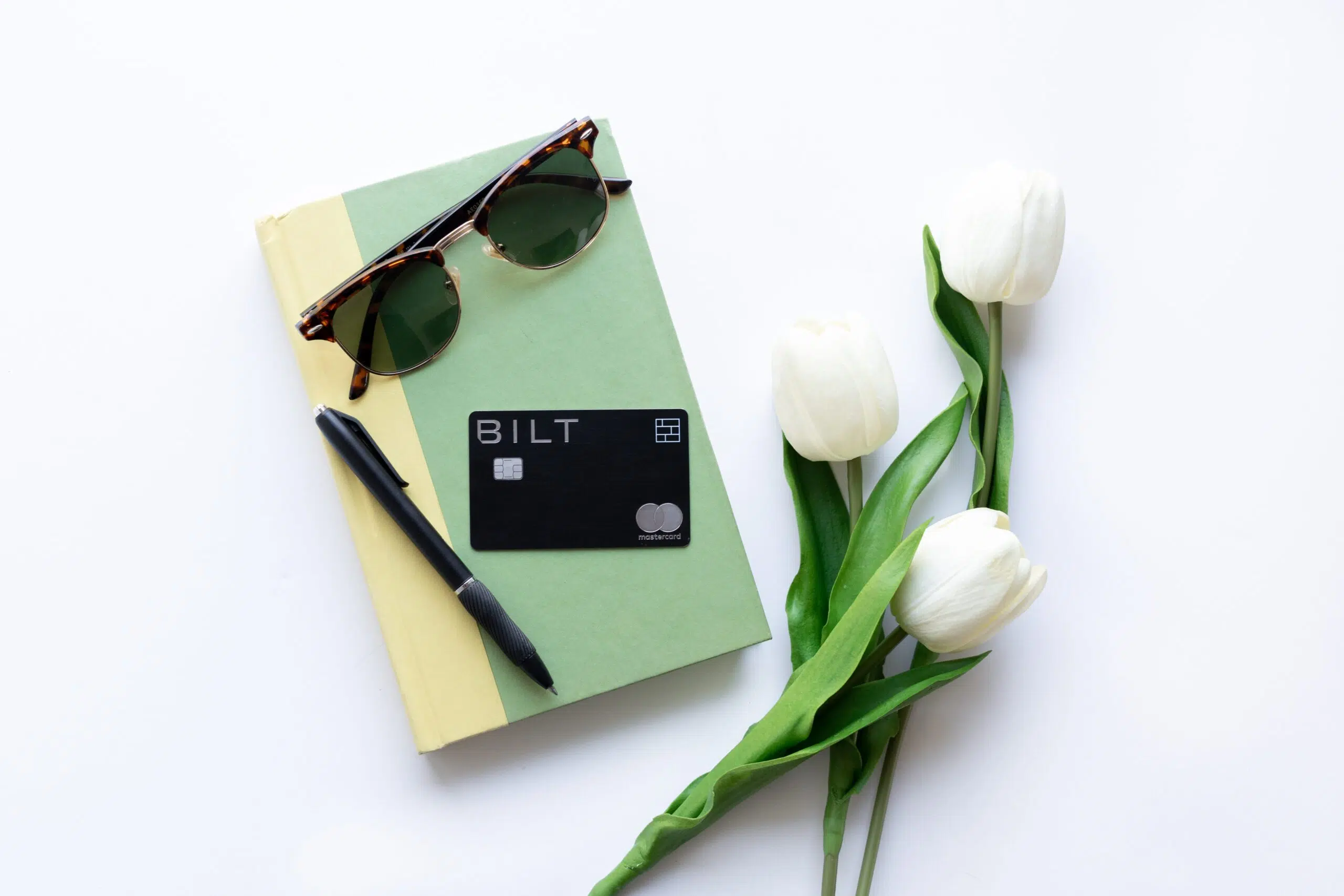 Bilt Rewards Mastercard on a book with flowers