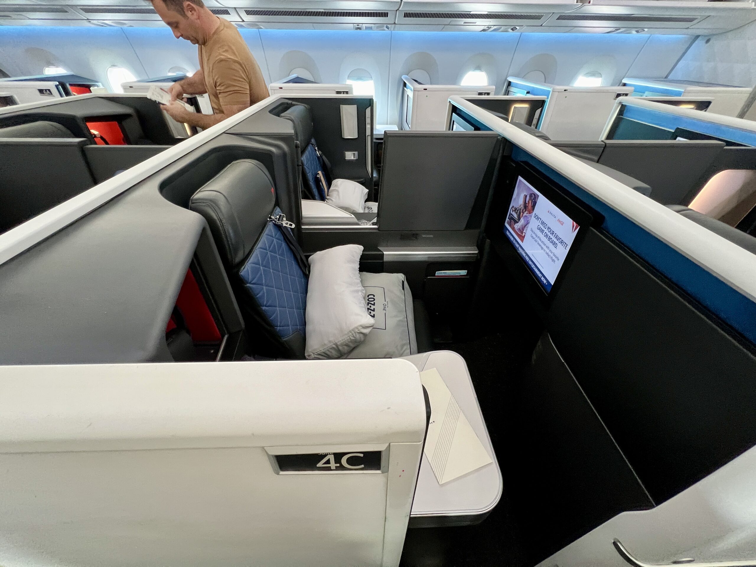 delta one suites with a passenger in the cabin