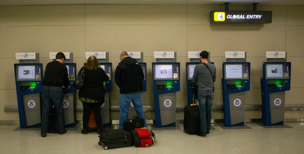 travelers at global entry kiosks