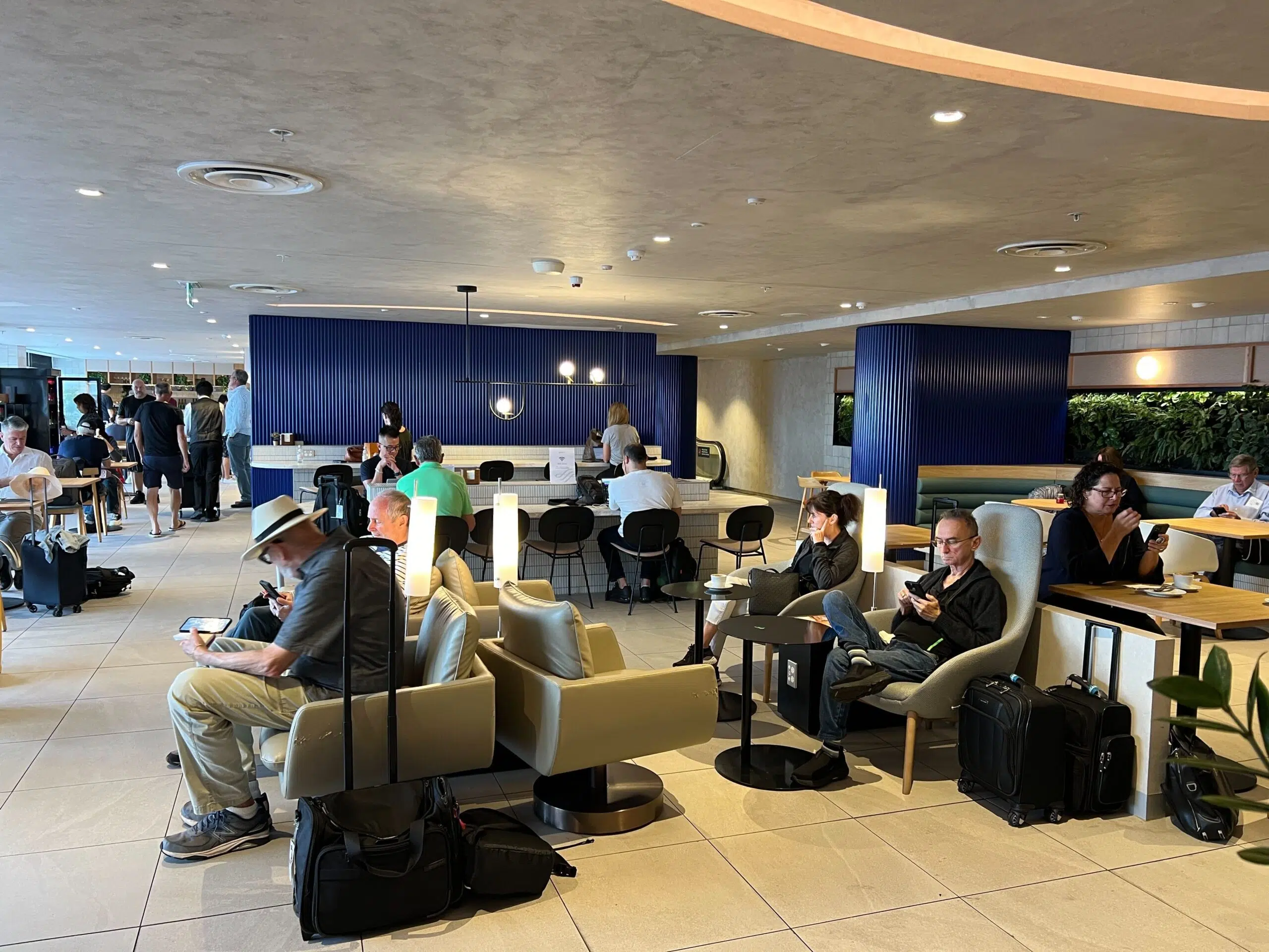 people sitting on chairs in the skyteam lounge in sydney