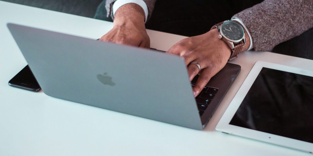 man with laptop iphone and ipad