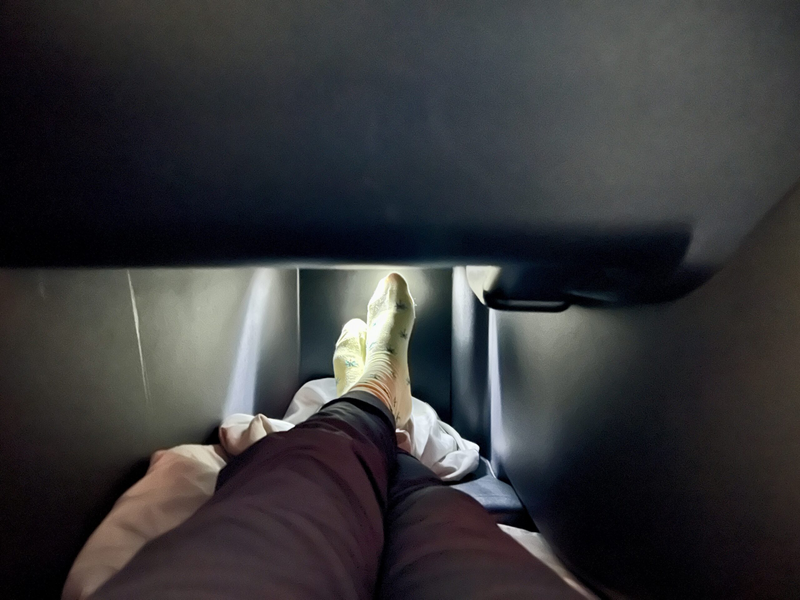 legs in a business class seat