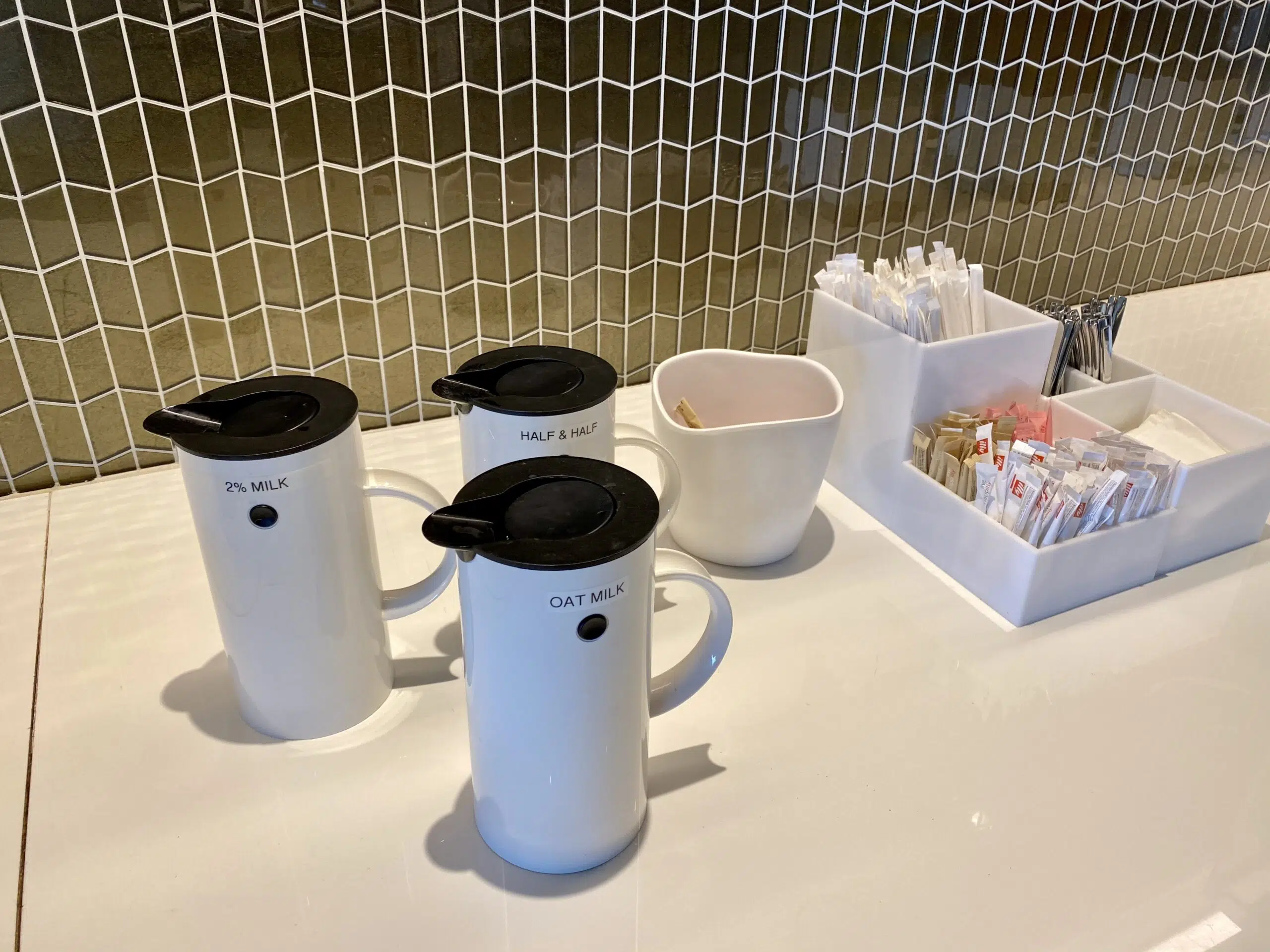 coffee station with containers of milk and sugar