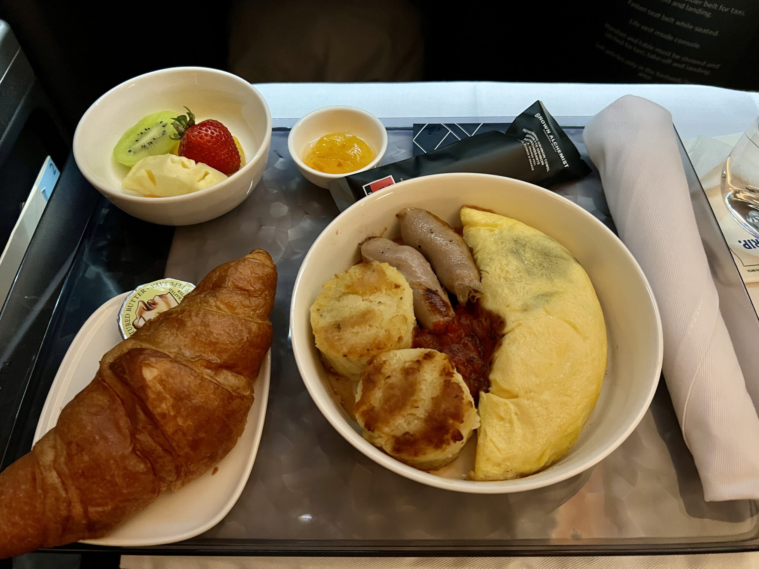 breakfast platter with omelet, croissant, fruit