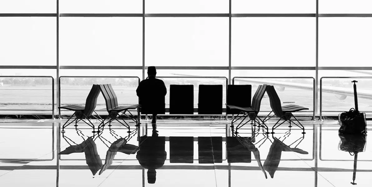 person waiting by their gate at the airport