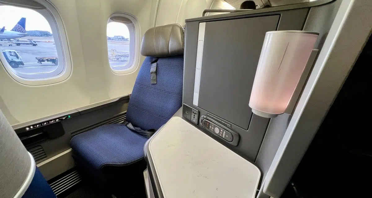 united polaris business class seat with planes outside the window