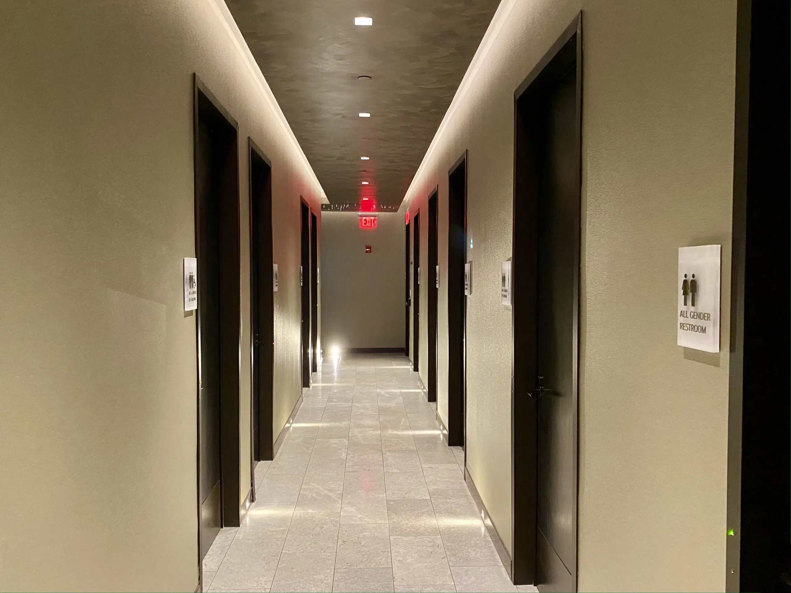 a corridor with individual bathrooms