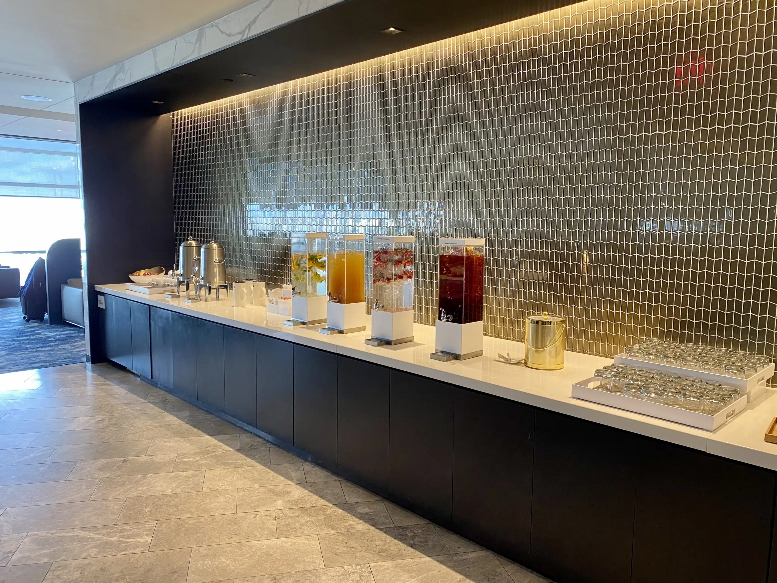 long bar surface with drink containers and glasses